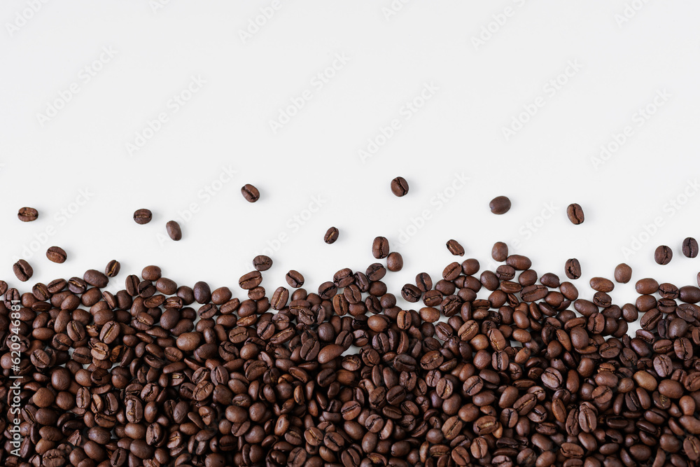 Roasted black coffee beans on white background with copy space Roasted black coffee beans on white background with copy space