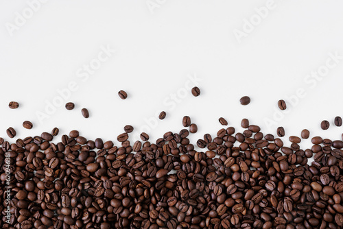 Roasted black coffee beans on white background with copy space