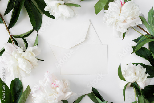 Open envelope with a letter and peonies, place for your text