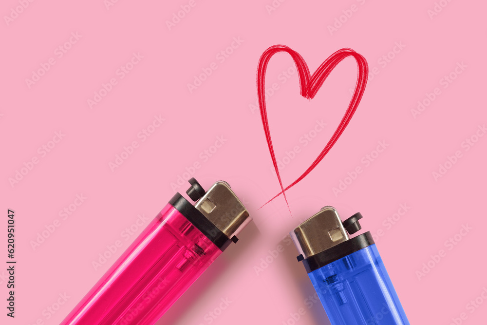 Pink and blue lighters with heart on pink background - Concept of love Pink and blue lighters with heart on pink background - Concept of love