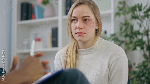Woman domestic violence survivor talking to psychotherapist, successful treatment photo