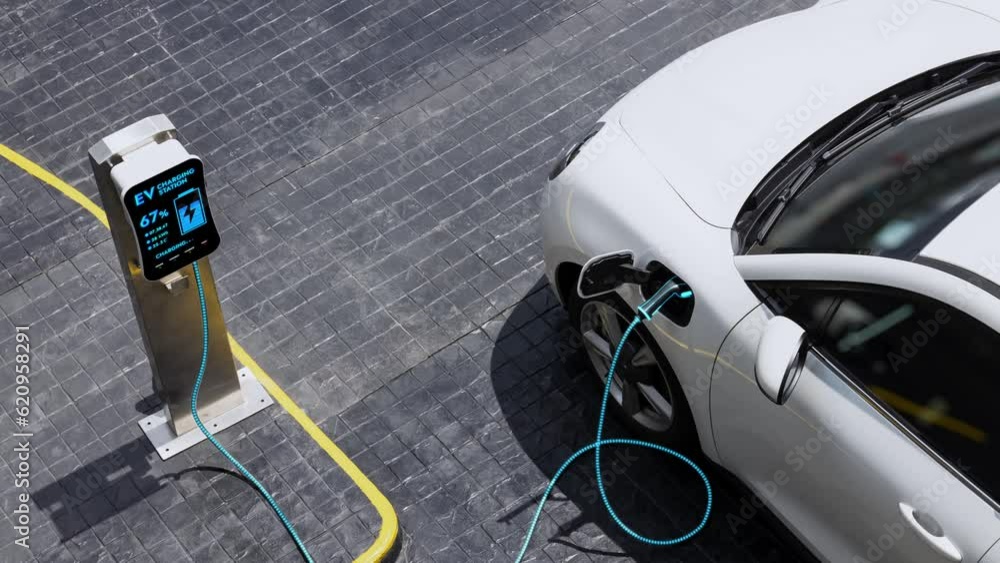 Aerial view electric car recharging battery from EV charging station at ...
