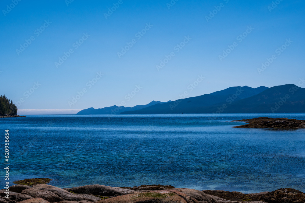 sea  sky and mountains  with rocky beach foreground shot in fitz hugh sound, british columbia