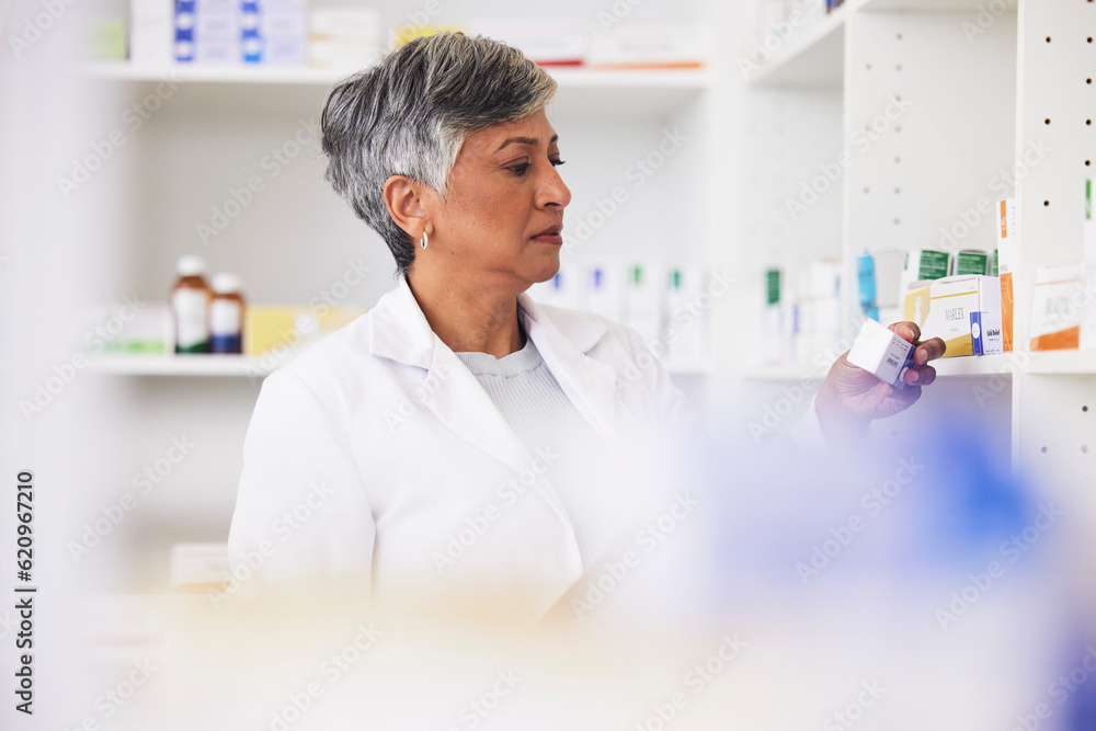 Pharmacist, shelf and a woman reading a medicine box label in a pharmacy for knowledge. Mature female employee in healthcare, pharmaceutical and medical industry to check product information on stock