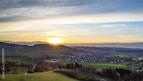 Wallpaper Mural Dawn illuminates a town in a hilly valley with forests and meadows Torontodigital.ca