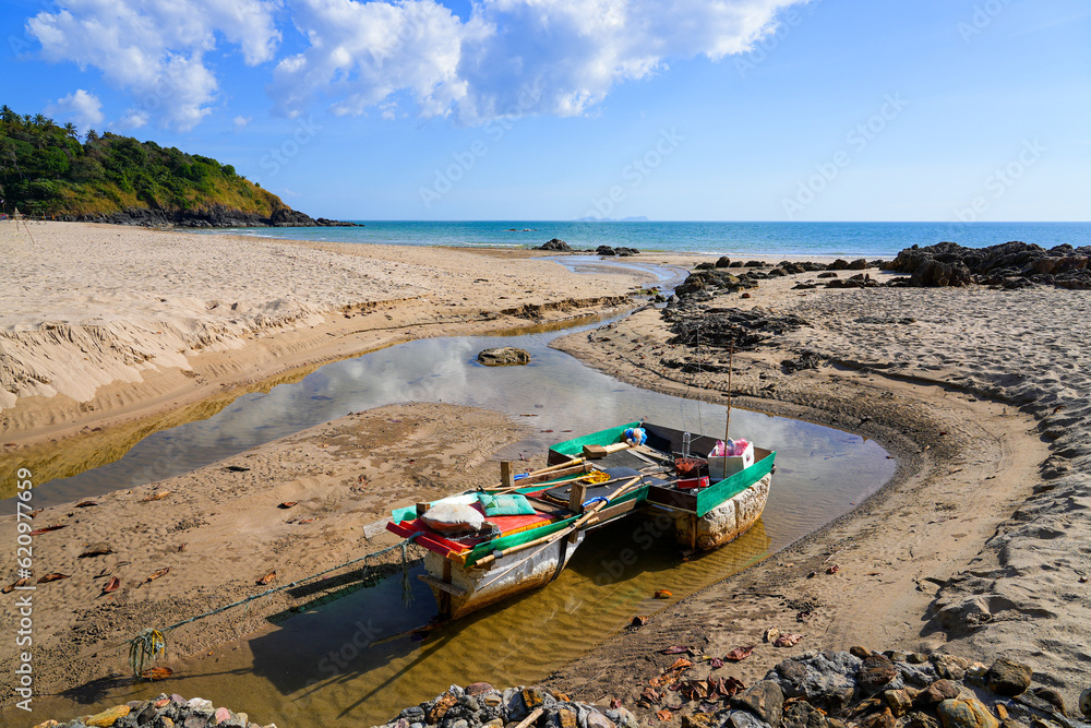 Small fishing boat on a creek coming out of the jungle on Khlong Chak Beach, Koh Lanta Yai island, Krabi province, Thailand Small fishing boat on a creek coming out of the jungle on Khlong Chak Beach, Koh Lanta Yai island, Krabi province, Thailand