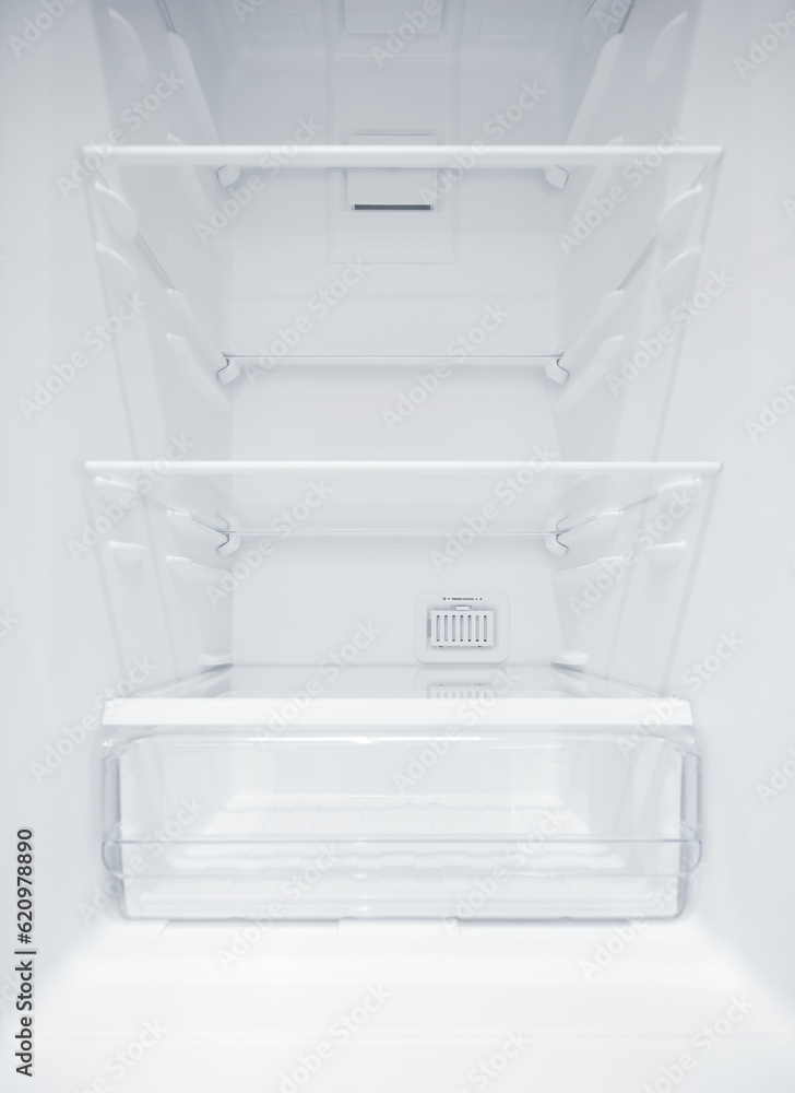 An empty refrigerator. Inside an empty, clean refrigerator, a refrigerator compartment after defrosting. shot with a wide angle lens An empty refrigerator. Inside an empty, clean refrigerator, a refrigerator compartment after defrosting. shot with a wide angle lens