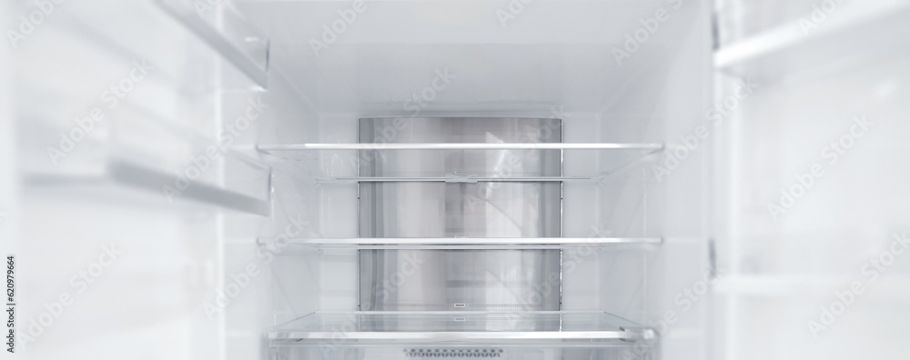 An empty refrigerator. Inside an empty, clean refrigerator, a refrigerator compartment after defrosting. shot with a wide angle lens An empty refrigerator. Inside an empty, clean refrigerator, a refrigerator compartment after defrosting. shot with a wide angle lens