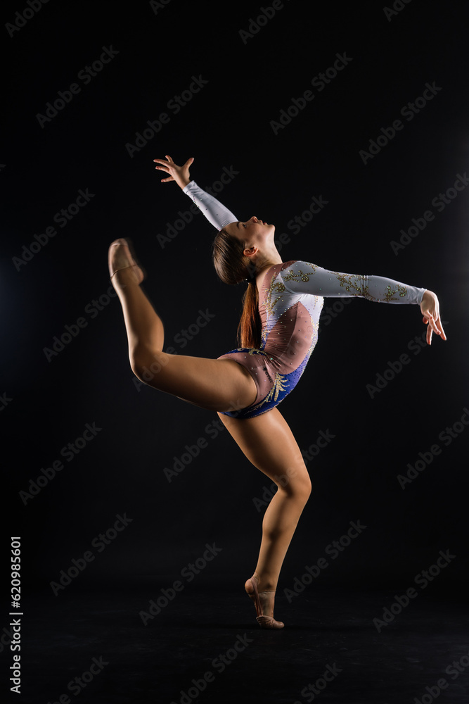 Fashion girl ballet dancer. Sport gymnastics studio shot on white and black background