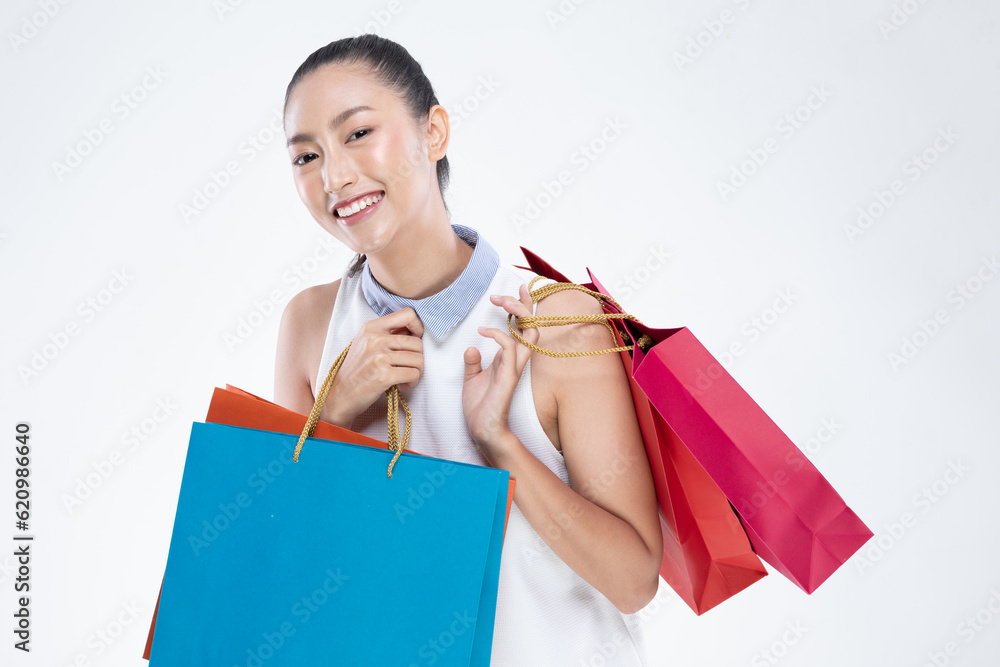 Beautiful Attractive Asian Woman smile and holding shopping bags feeling so happiness and enjoy with black Friday sale in Shopping mall,isolated on white background. Shopping Lifestyle Concept Beautiful Attractive Asian Woman smile and holding shopping bags feeling so happiness and enjoy with black Friday sale in Shopping mall,isolated on white background. Shopping Lifestyle Concept