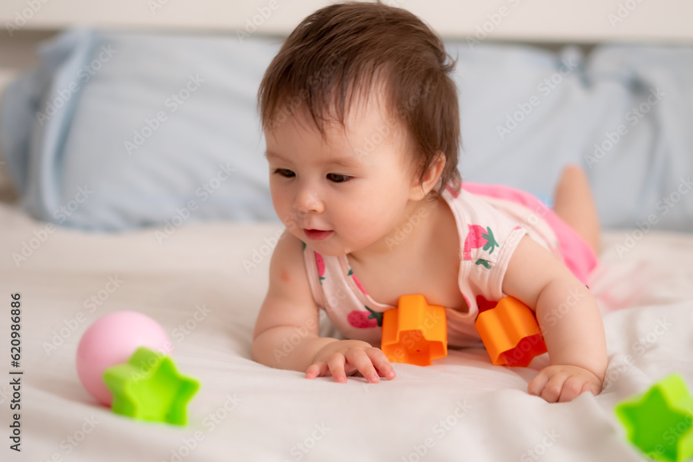 lifestyle home portrait of sweet and adorable mixed ethnicity Asian Caucasian baby girl playing with color blocks on bed excited and happy in childhood concept lifestyle home portrait of sweet and adorable mixed ethnicity Asian Caucasian baby girl playing with color blocks on bed excited and happy in childhood concept