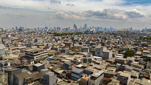 Houses in the slums of Jakarta and the panorama of the city. Indonesia.