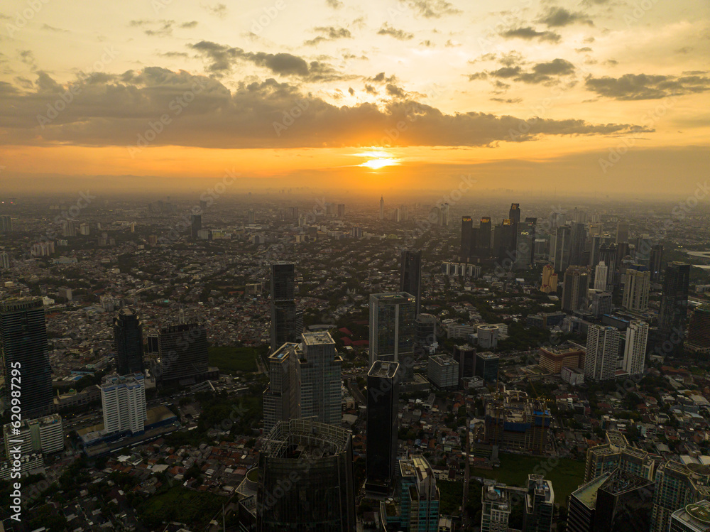 Aerial drone of Jakarta with modern buildings at sunset. Urban landscape. Indonesia.