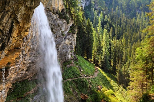 Johannes Waterfall (Johanneswasserfall) in Obertauern. It has tourist trail beneath the waterfall. Natural landmark of Tauern mountains in Austria. photo