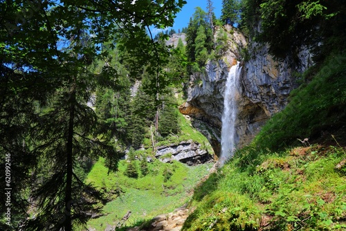 Johannes Waterfall (Johanneswasserfall) in Obertauern. It has tourist trail beneath the waterfall. Natural landmark of Tauern mountains in Austria.