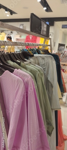 Clothing on hanger at the trendy shop boutique stock photo