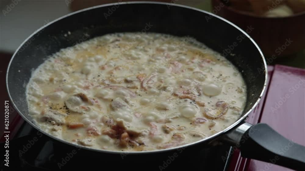 chicken meat boiling in creamy sauce in pan close up chicken meat boiling in creamy sauce in pan close up