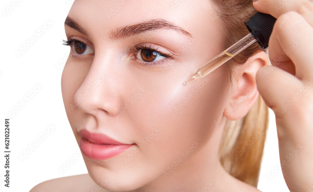 Woman applying cosmetics remedy on beautifu face.