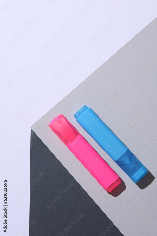 Markers on the corner of gray cube. Optical geometric illusion. Creative layout. Minimalism