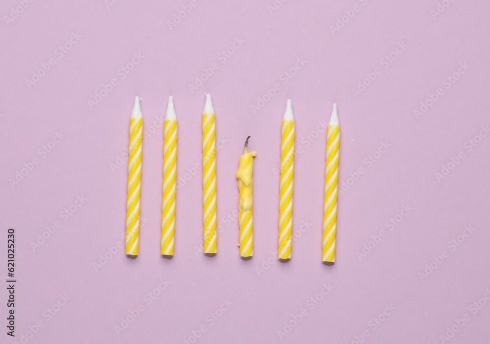 Yellow birthday candles on pastel background. Minimalism party concept