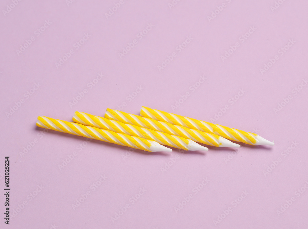 Yellow birthday candles on pastel background. Minimalism party concept