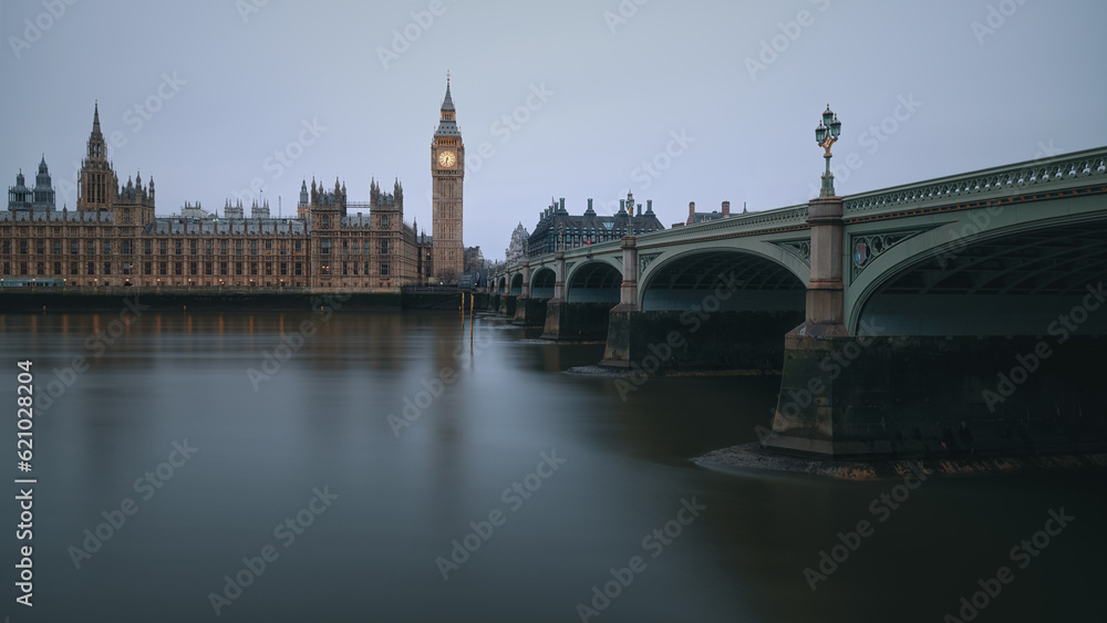 The Westminster Bridge and the Big Ben clocktower by the Thames river in London at dawn, United Kingdom