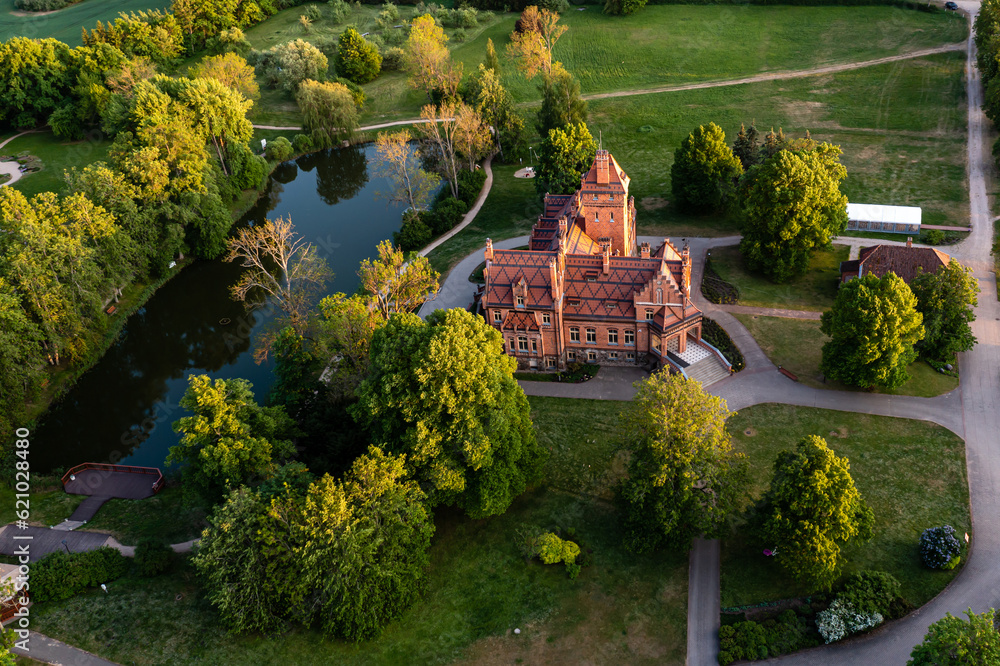 Fototapeta premium Jaunmoku brick medieval castle and its territory near Tukums, Latvia, drone view