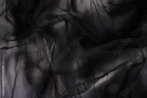 Closeup background of black mesh texture with many pleats © Alina 