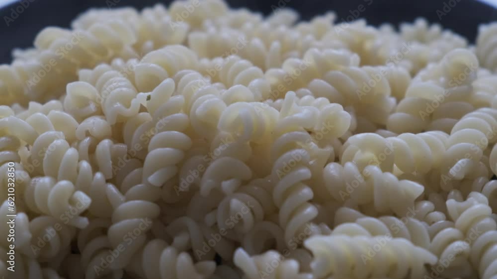 Pasta with tomatoes on a black plate in a rotating display window Pasta with tomatoes on a black plate in a rotating display window