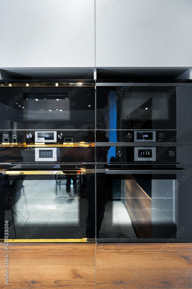New ovens in household appliance section in store New ovens in household appliance section in store