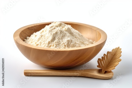 a wooden dish with flour and a flour scoop. Wheat or rice flour is seen in isolation on a white backdrop.