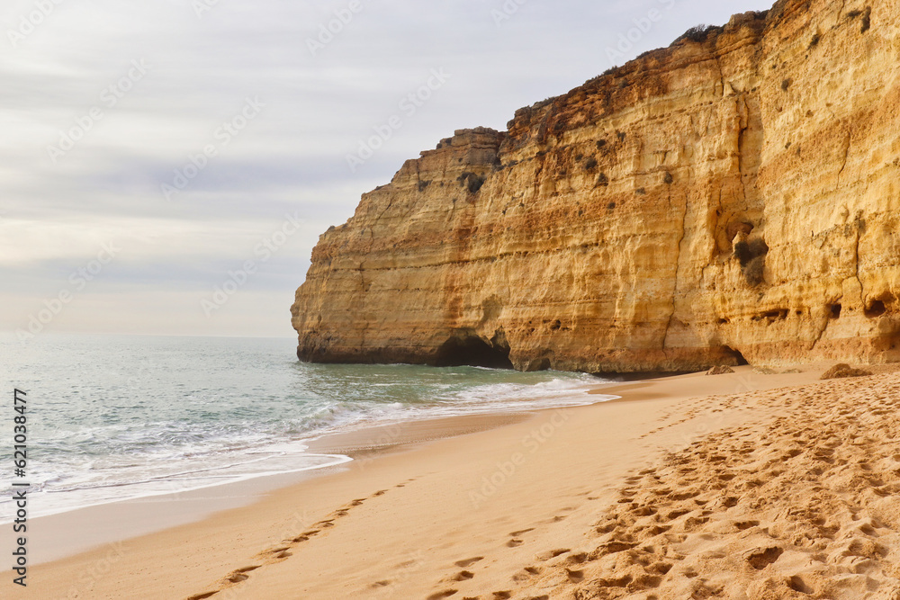 Sandy beach with limestone cliff on a winter day in southern Portugal.