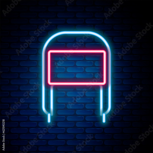 Glowing neon line Winter hat with ear flaps icon isolated on brick wall background. Colorful outline concept. Vector