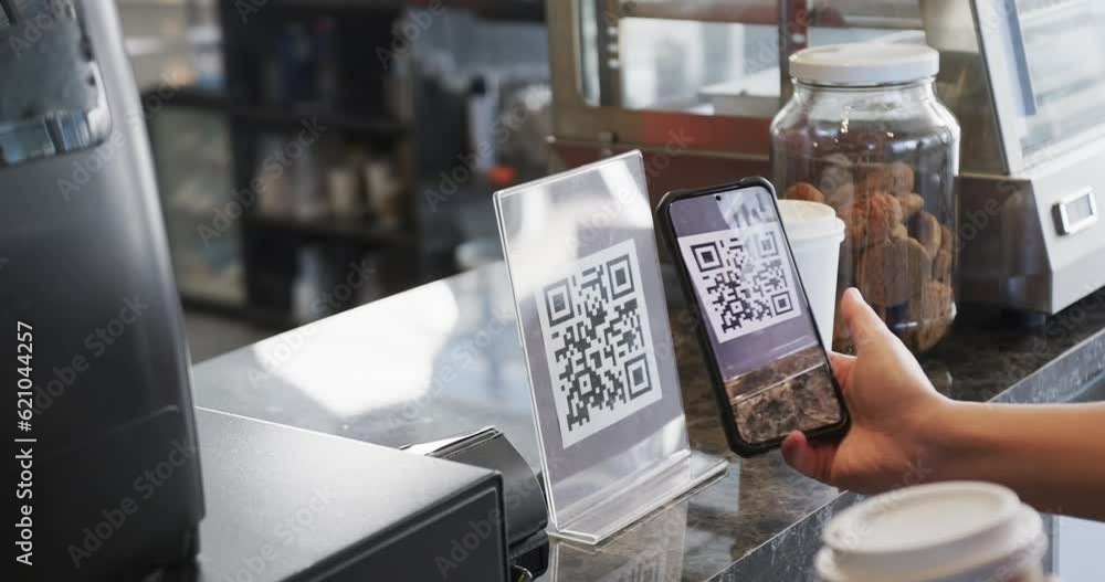 Caucasian customer scanning qr code with smartphone in bakery in slow motion