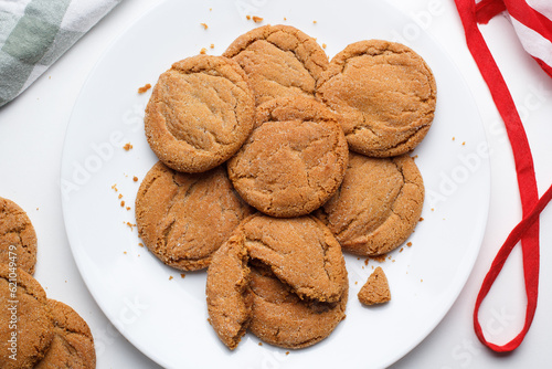 Freshly baked ginger sparkle molasses cookies on a kitchen plate. photo
