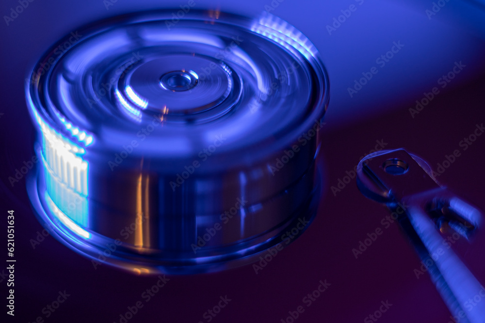 Computer hard drive without protective cover. Close up of hard disk with abstract reflection. Opened hard drive from the computer hdd with mirror effects Part of computer pc. Soft selective focus Computer hard drive without protective cover. Close up of hard disk with abstract reflection. Opened hard drive from the computer hdd with mirror effects Part of computer pc. Soft selective focus