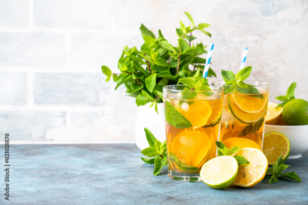 Fototapeta premium Iced tea. Summer drink with lemon, lime, mint and ice. Cold lemonade.
