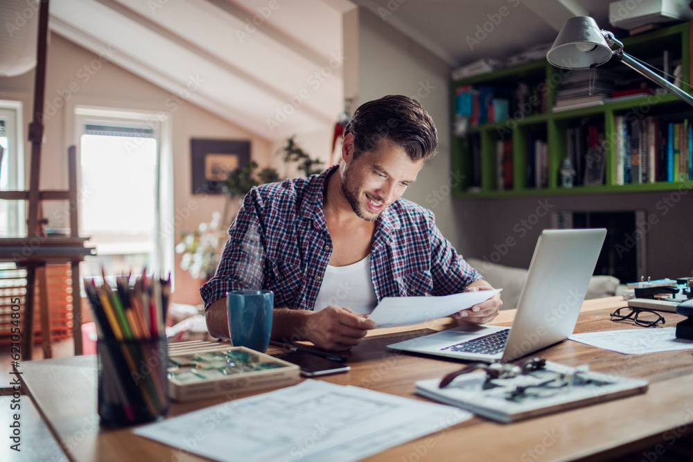 Young man working from home on his laptop Young man working from home on his laptop