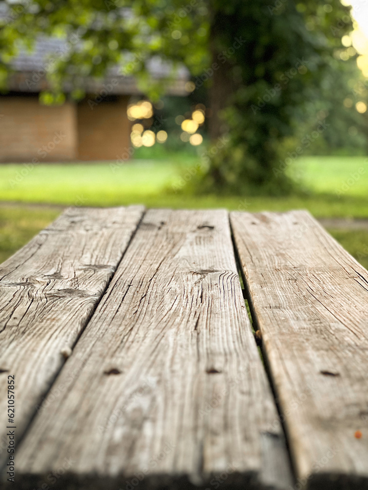 Closeup of a wooden picnic table in the park at sunset Closeup of a wooden picnic table in the park at sunset