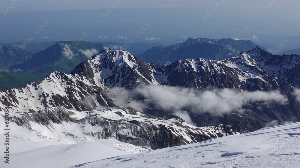 Fototapeta premium Mountains under snow in the clouds. The foothills of Kazbek