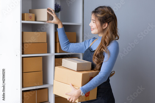 Portrait of Starting small businesses SME owners female entrepreneurs working on receipt box and check online orders to prepare to pack the boxes, sell to customers, SME business ideas online. 