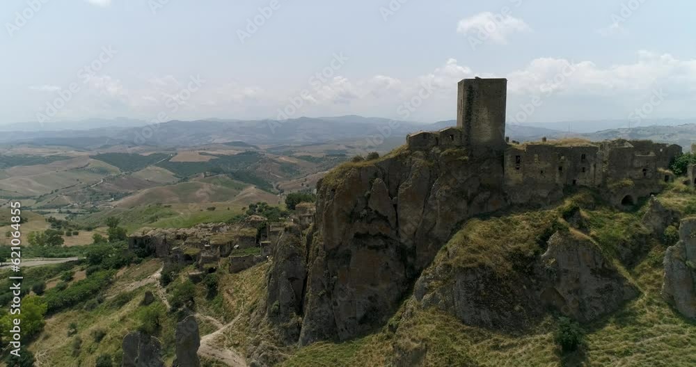 Aerial drone view in Craco, Italy. Small town built on a clay hill. Ghost town causes landslides and earthquake. An isolated ghost town set famous for horror films and dramatic sceneries. Aerial drone view in Craco, Italy. Small town built on a clay hill. Ghost town causes landslides and earthquake. An isolated ghost town set famous for horror films and dramatic sceneries.