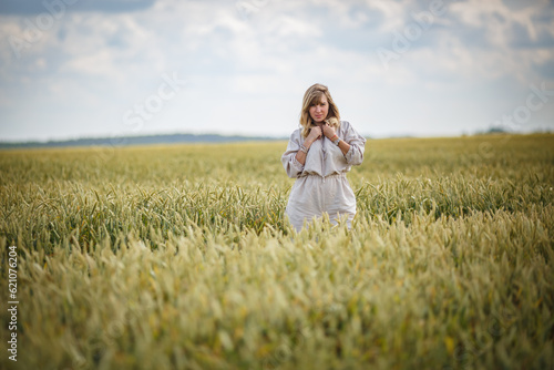 beautiful girl in a linen dress in a wheat field