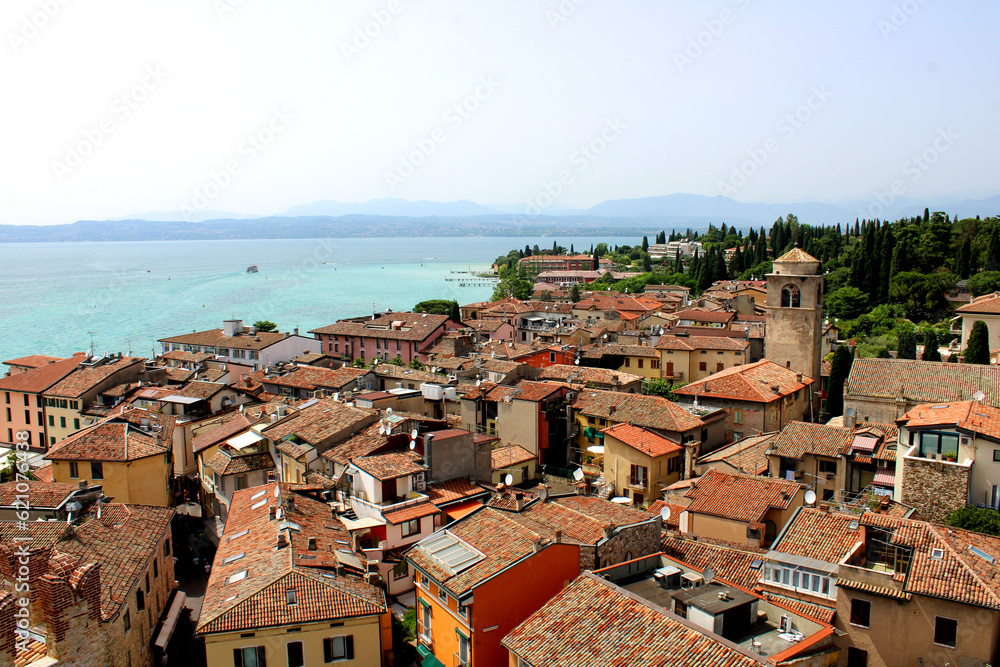 Stunning view of the italian rooftops of Sirmione from above with clear blue Lake Garda in the background