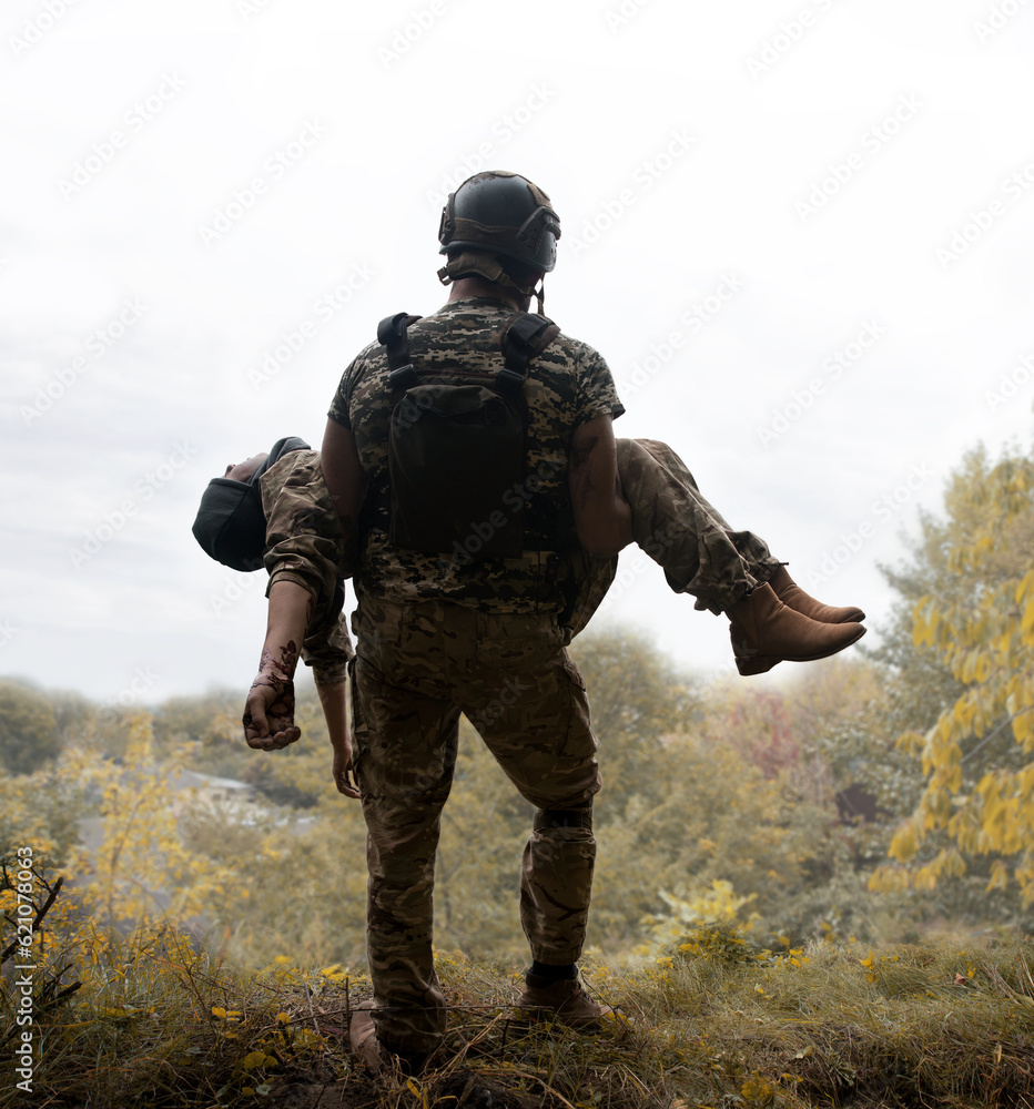 The commander carries a wounded soldier The commander carries a wounded soldier