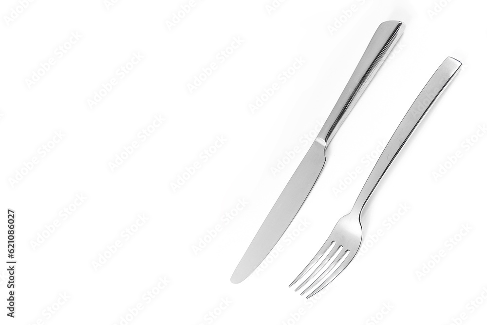 Knife and fork isolated on white background. Elegant shiny cutlery set Knife and fork isolated on white background. Elegant shiny cutlery set