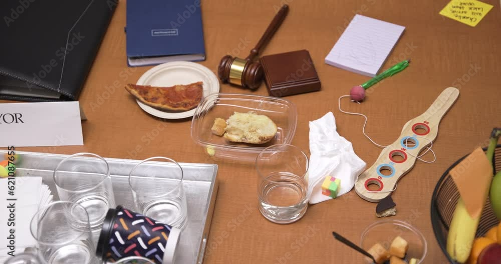 Messy conference table with drinks, gavel and mayor title card Messy conference table with drinks, gavel and mayor title card
