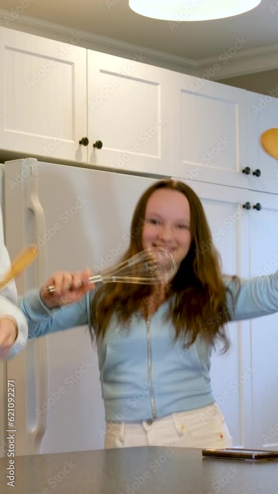 boy and girl in kitchen playing fighting dancing having fun spending time together fooling around eating sushi. cat dancing to music waving hands kitchen utensils having fun alone at home no parents
