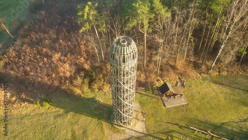 Wooden lookout tower in Hermanice on sunny spring day, Czech Republic. Aerial 4K footage from drone flight photo