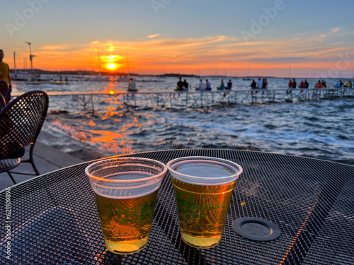 MADISON, WISCONSIN, JULY 16 2022: Drinking two beers during summer sunset at Madison Memorial Union photo